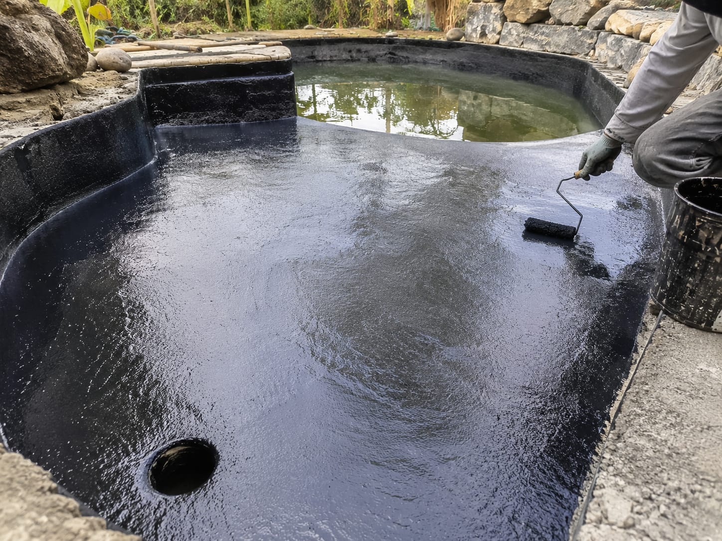 Pond waterproofing coating applied to a water feature